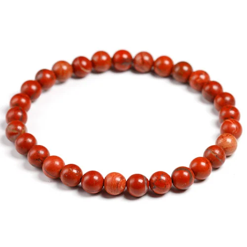 Pulsera jaspe rojo 6 mm con cuentas naturales pulidas en tono rojo sobre fondo neutro